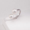 Silver ring with pearls on a white surface